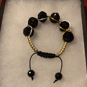 Handmade and crafted Black Beaded Shamballa Bracelet with gold and white cord.